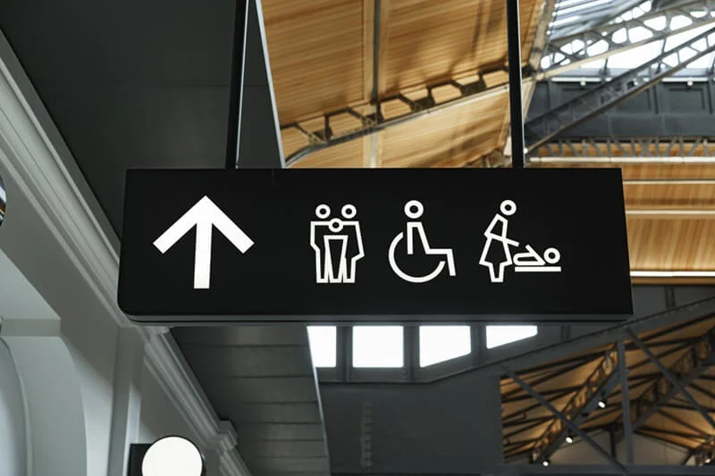 An image of monochromatic bathroom wayfinding signage using icons.